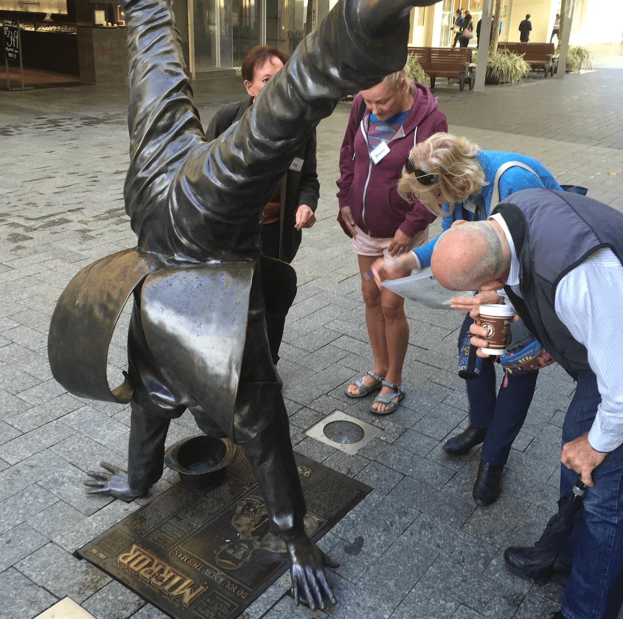 Team photographing a Perth landmark while solving a scavenger hunt clue
