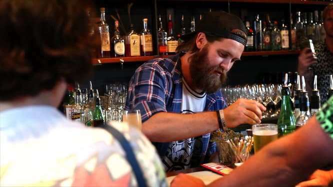 Bartender preparing drinks at a Perth small bar on an evening walking tour